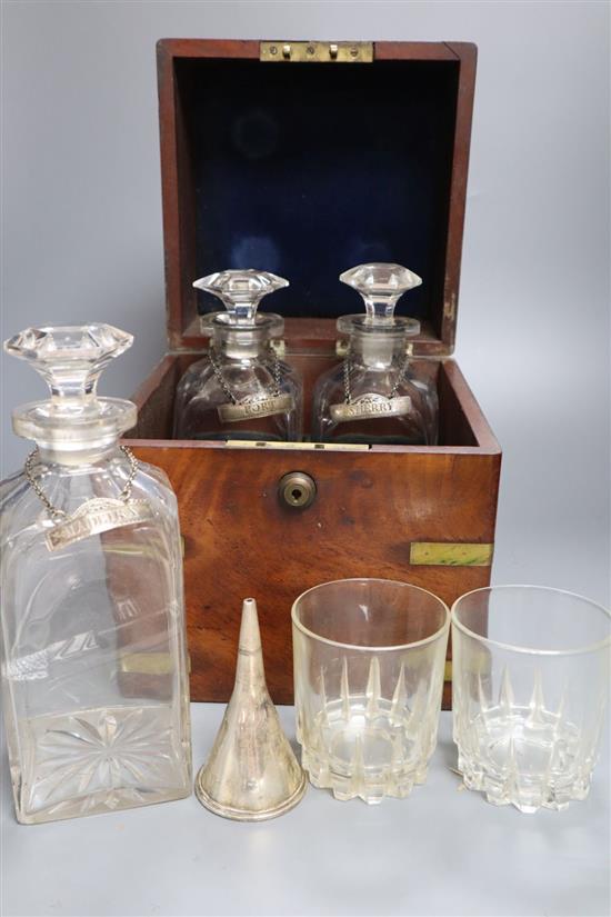 A mid 19th century mahogany and brass bound decanter case, containing three decanters and two associated glasses and a silver plated wi
